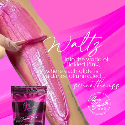 Sexy Smooth Wax Tickled Pink hard wax being applied to skin with a waxing spatula, showing its smooth pink texture.
